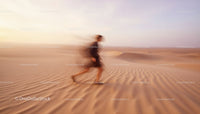Woman Dancing in a Flowing Dress on Golden Desert Sands