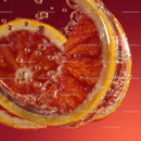 Close-up of Blood Orange Slices with Bubbles in Refreshing Water