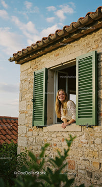 Smiling Woman by a Rustic Window with Green Shutters