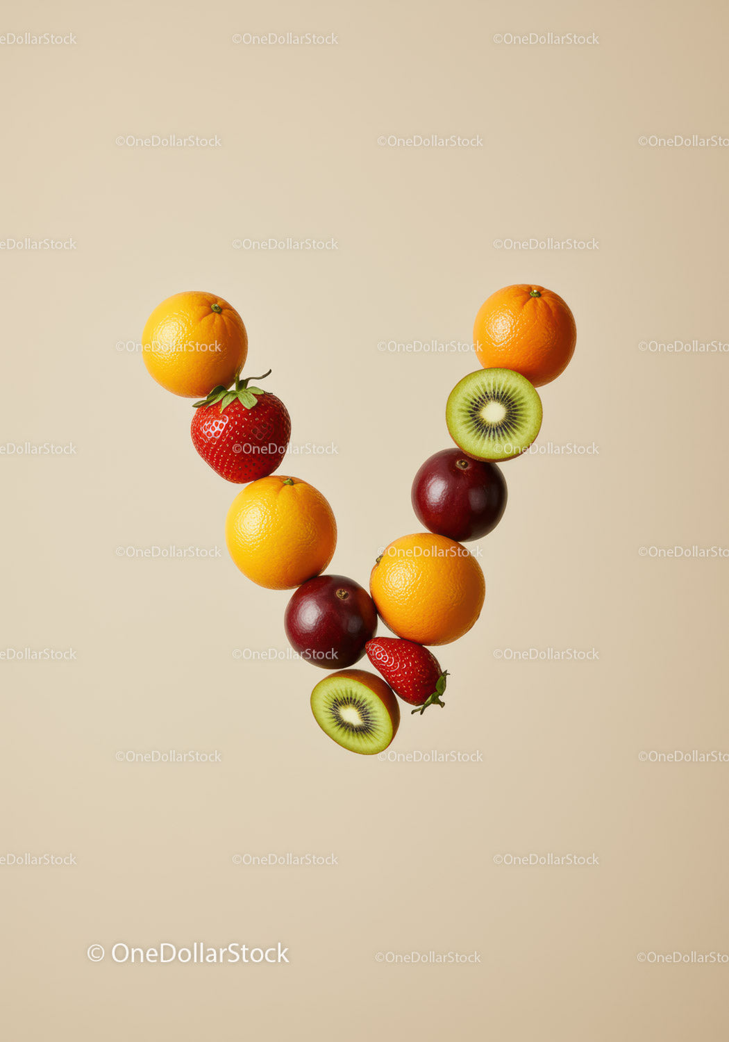 V-shaped arrangement of fresh colorful fruits on beige