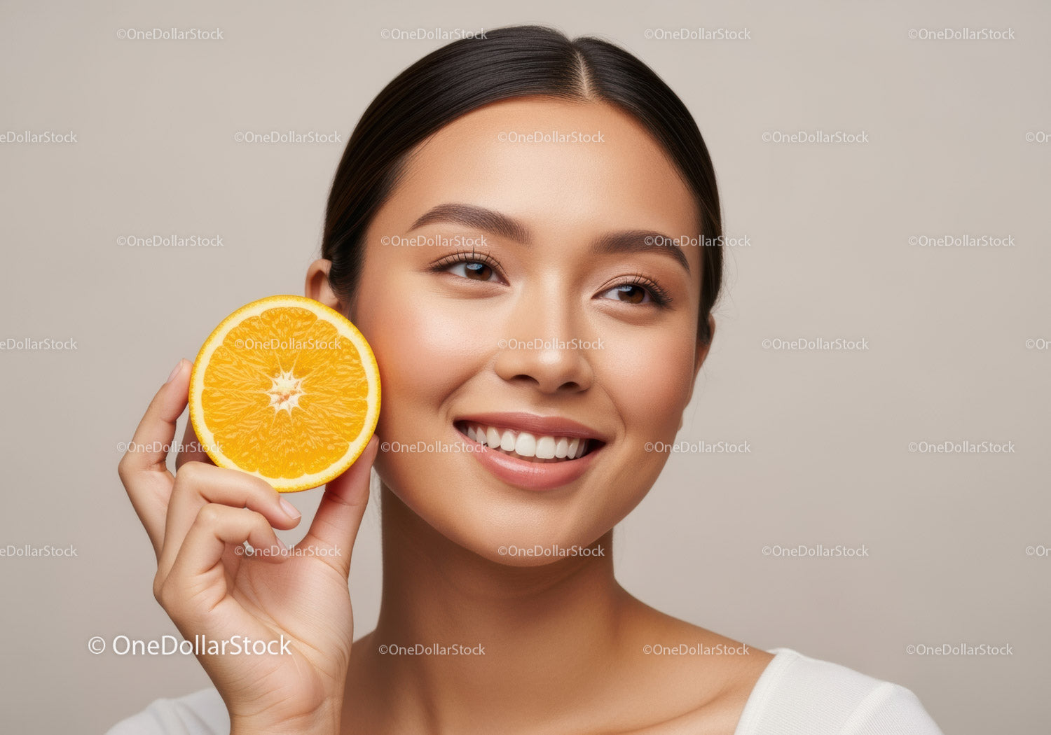 Women Smiling with Fresh Orange Half for Natural Skin Glow