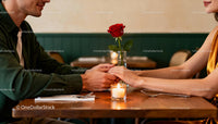 Couple Holding Hands Across Romantic Candlelit Dinner Table