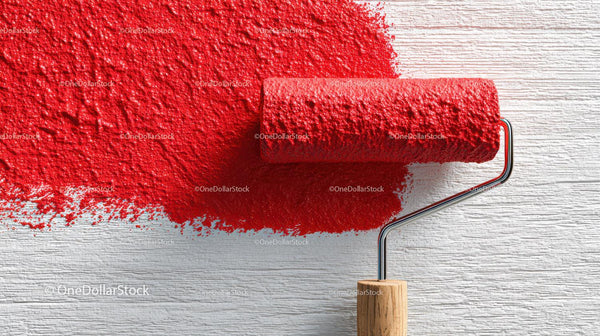 Red Paint Being Applied with a Roller on Wall Surface