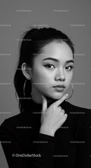 Elegant Black and White Portrait of Young Woman with Hoop Earrings