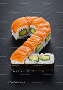 Sushi Rolls Arranged in Question Mark Shape on Black Surface