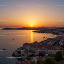 Beautiful Sunset Over Coastal Village With Red Roofs and Sailing Boats