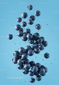 Fresh blueberries suspended in sparkling water splash