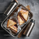 Ham and Cheese Toasted Sandwiches in Aluminum Foil with Metal Bottles