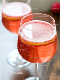 Elegant Pink Sparkling Wine Glasses with Citrus Garnish for Celebration