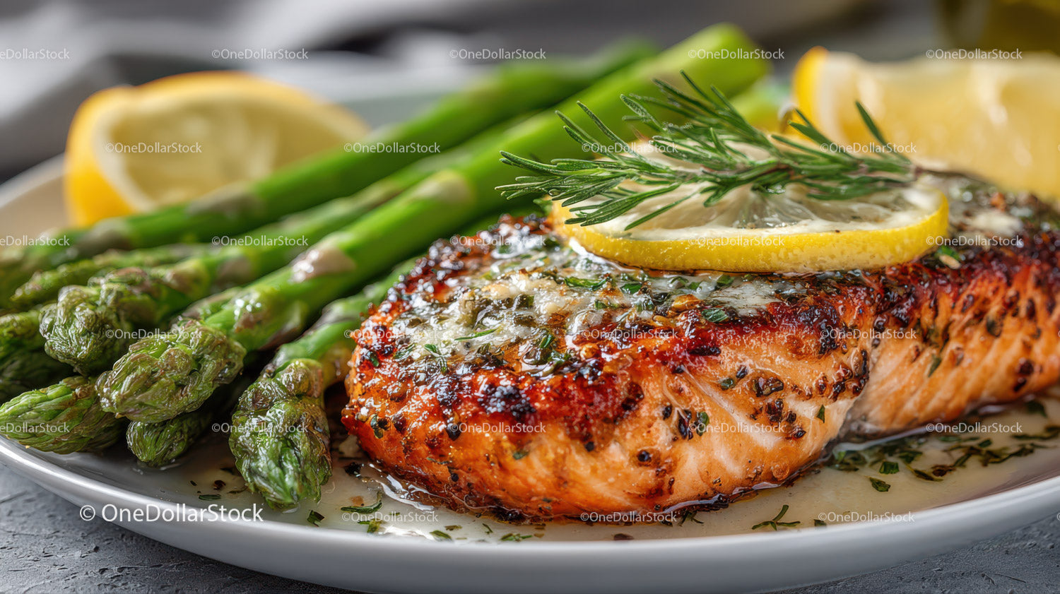Grilled Salmon with Lemon Slices and Asparagus on White Plate