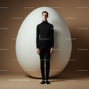 Serene young man standing still beside giant egg