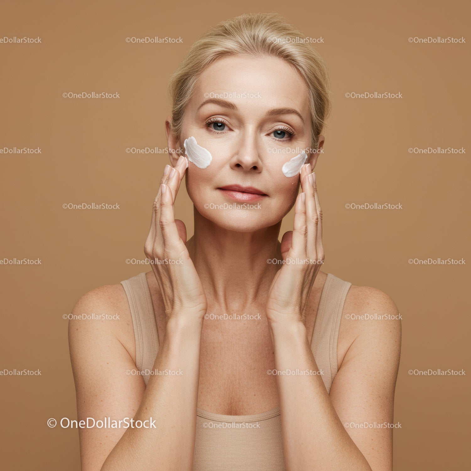 Elegant Mature Woman Applying Skincare Cream for Youthful Skin