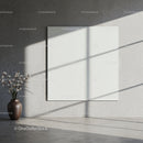 Minimalist room with ceramic vase and blank canvas
