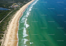 Aerial View of Turquoise Ocean and Sandy Beach with Coastal Vegetation