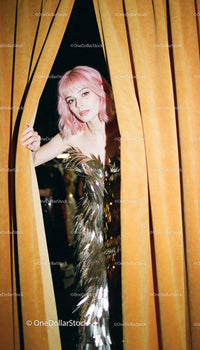 Woman with Pink Hair Peeking Through Velvet Curtains