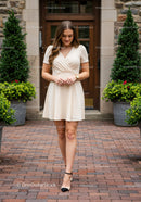 Elegant Woman Walking on Brick Pathway in Stylish Dress