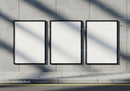 Three Blank Posters on Urban Concrete Wall with Shadows