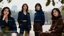 Stylish women posing confidently in autumn park