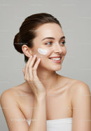 Young Woman Applying Skincare Cream for Glowing Natural Skin