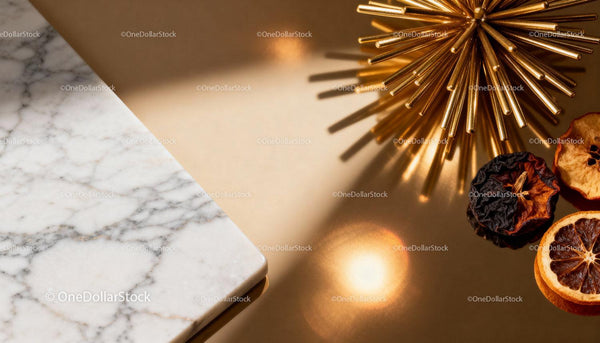Golden decorative star with dried citrus on marble surface