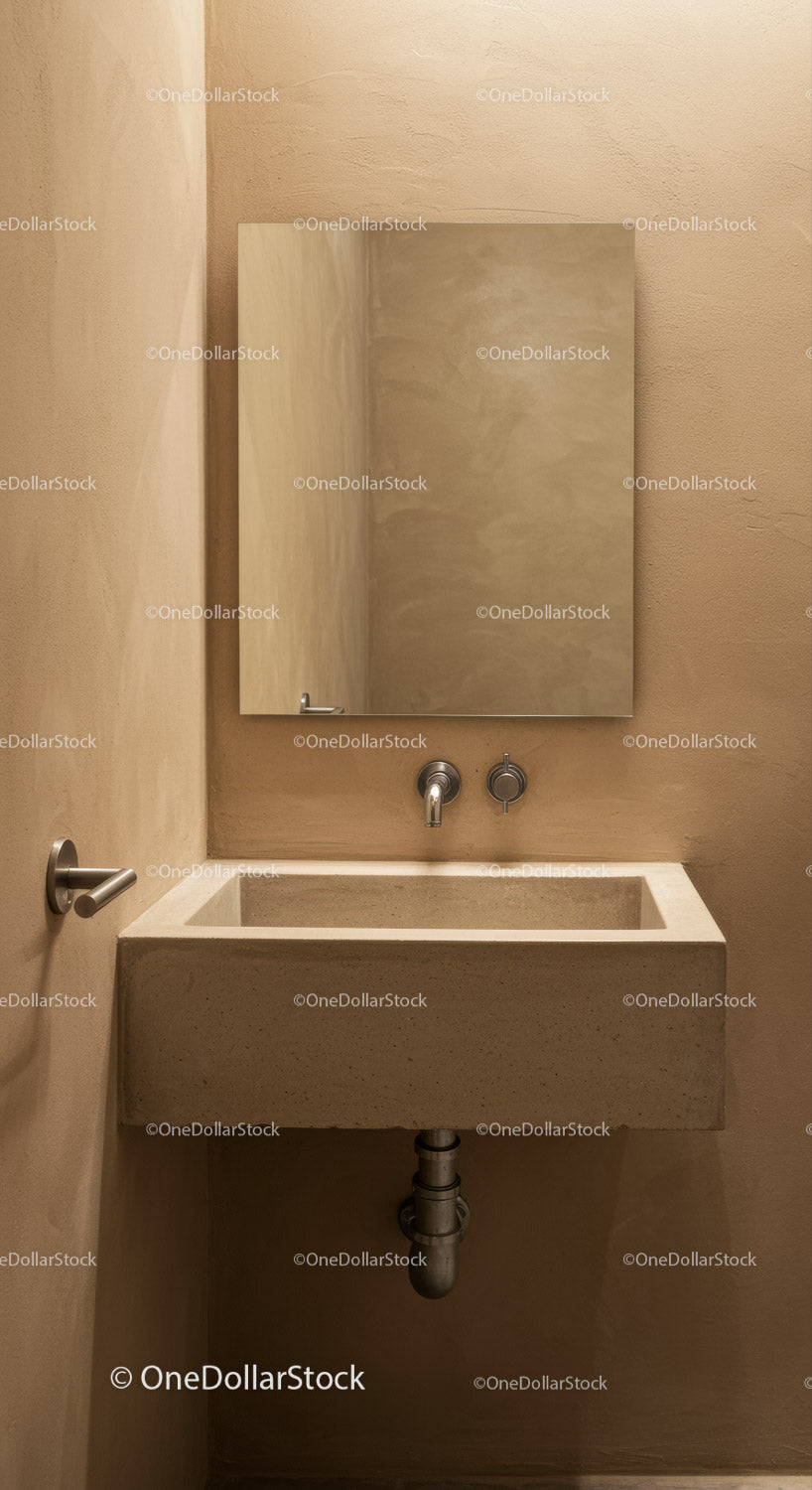 Concrete Sink and Wall-Mounted Faucet in Modern Minimalist Bathroom