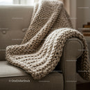 Cozy chunky knit blanket draped on gray sofa armrest