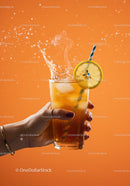 Hand Holding Iced Tea with Lemon Slice Splash