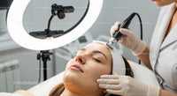 Woman Receiving Advanced Laser Facial Treatment in a Modern Clinic