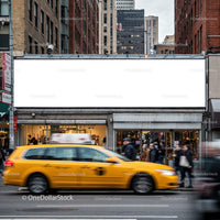 Busy city street with iconic yellow taxi and blank billboard