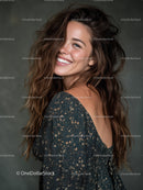 Portrait of a Smiling Woman with Wavy Hair in Stylish Dress