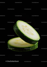 Fresh Zucchini Slices with Bright Green Skin on Black
