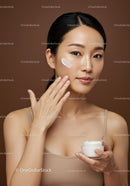 Young Woman with Clear Skin Applying Moisturizer in Skincare Routine