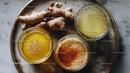 Herbal Remedies with Fresh Ginger and Turmeric in Glass Bowls