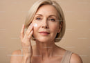 Portrait of a Mature Woman Applying Skincare Cream