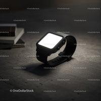 Minimalistic black smartwatch glowing on concrete surface