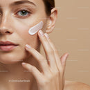 Close-up of Woman Applying Skincare Cream to Face with Freckles