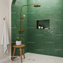 Modern bathroom with green tiled shower and brass fixtures