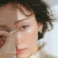 Close-Up of a Woman Applying Eye Shadow with a Makeup Brush