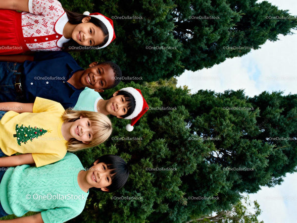 Smiling diverse children in festive holiday attire outdoors