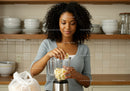 Young Woman Preparing Banana Smoothie in Modern Kitchen
