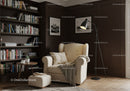 Cozy reading corner with beige armchair and dark wood shelves