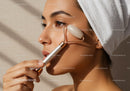 Woman Receiving Beauty Facial Treatment with Jade Roller for Healthy Skin
