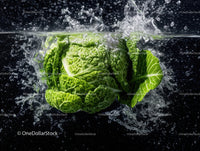 Fresh Green Cabbage Against Black Background with Water Splash