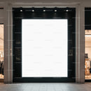 Large illuminated blank storefront billboard at mall entrance