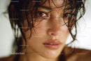 Young Woman with Wet Hair and Intense Gaze in Natural Lighting