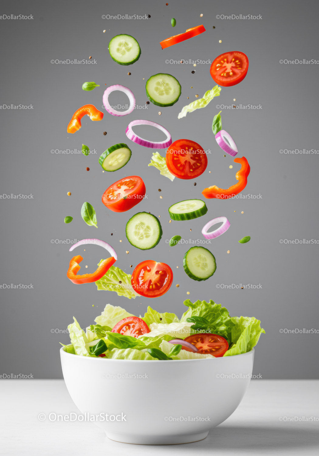 Fresh vegetable salad ingredients falling into bowl
