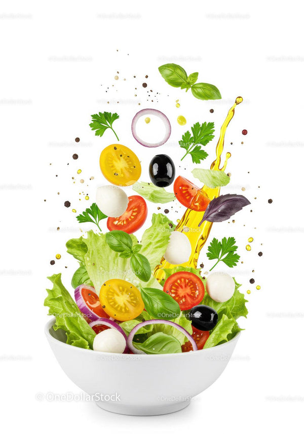 Fresh colorful Mediterranean salad ingredients flying over bowl