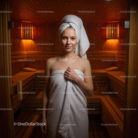 Relaxing Woman in Sauna Towel with Warm Wooden Interior