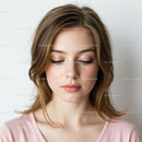 Professional Portrait of a Young Woman with Soft Makeup and Calm Expression