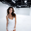 Elegant Woman in White Dress in Studio with Bright Lighting